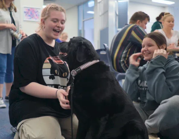 warakirri campbelltown student happy playing with guide dog